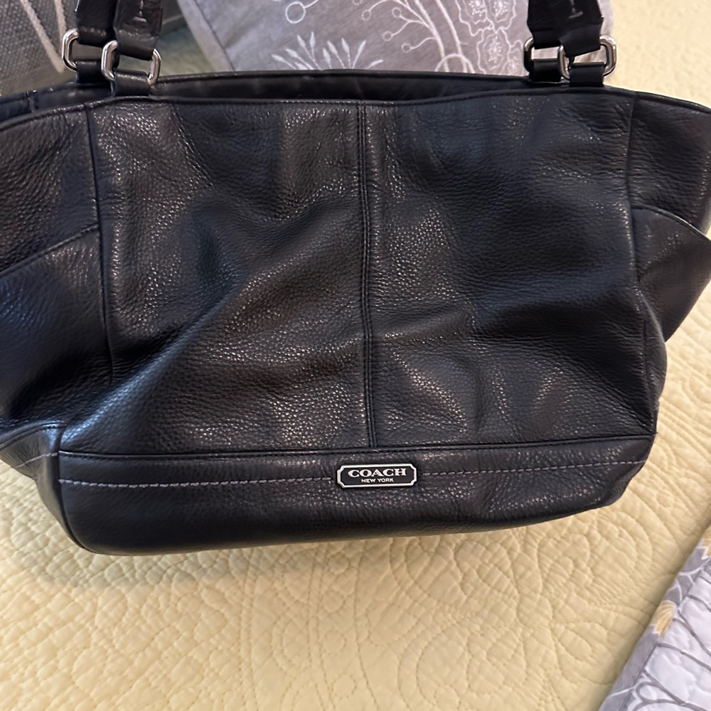 Coach black leather bag with green lining.